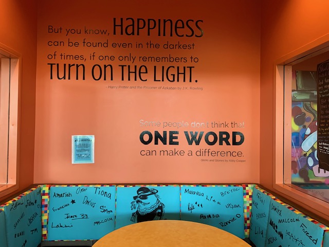 a photo showing how the urban teen department of a library in Charlotte, NC has decorated its wall space with vinyl quotes